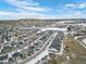 Aerial view of a neighborhood with houses and a hill in the background at 624 Simmental Loop, Castle Rock, CO 80104