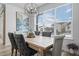 Bright dining area with a farmhouse table and gray upholstered chairs at 624 Simmental Loop, Castle Rock, CO 80104