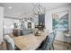 Bright dining room features a large wooden table and kitchen views at 624 Simmental Loop, Castle Rock, CO 80104