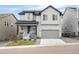Two-story home with gray siding, attached garage, and landscaping at 624 Simmental Loop, Castle Rock, CO 80104