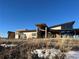 Modern home with a sloped roofline, large windows and stone accents at 624 Simmental Loop, Castle Rock, CO 80104