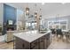 Modern kitchen with quartz counters, stainless steel appliances, and an open concept layout to the dining and living area at 624 Simmental Loop, Castle Rock, CO 80104