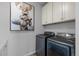 Laundry room with washer, dryer, and overhead cabinets at 624 Simmental Loop, Castle Rock, CO 80104