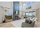 Bright open-concept living area with a cozy fireplace, high ceilings, and seamless access to the outdoor patio at 624 Simmental Loop, Castle Rock, CO 80104