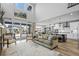 Bright open-concept living space featuring large windows, comfortable seating, and seamless flow to the kitchen and dining area at 624 Simmental Loop, Castle Rock, CO 80104