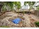 Wide-angle shot of backyard featuring rock beds, gardens, and wooden deck at 3679 S Zeno Way, Aurora, CO 80013