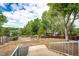 Expansive backyard with mature trees, lush landscaping, and deck, perfect for outdoor activities and relaxation at 3679 S Zeno Way, Aurora, CO 80013