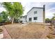 Spacious backyard showing the home's rear facade, patio, and large grassy area at 3679 S Zeno Way, Aurora, CO 80013