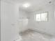 Unfinished basement area with a window for natural light and painted white walls at 3679 S Zeno Way, Aurora, CO 80013