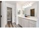 Bright bathroom with shower and vanity with a large mirror and modern lighting at 3679 S Zeno Way, Aurora, CO 80013