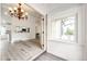 Inviting entryway that flows into the living room and kitchen, with natural light streaming through the window at 3679 S Zeno Way, Aurora, CO 80013