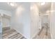 Bright hallway with laminate flooring and recessed lighting leads to other rooms at 3679 S Zeno Way, Aurora, CO 80013