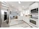 Modern kitchen featuring stainless steel appliances, light countertops, and views of the dining and loft area at 3679 S Zeno Way, Aurora, CO 80013