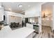 Modern kitchen with white cabinets, quartz countertops, stainless steel appliances, and adjoining dining area at 3679 S Zeno Way, Aurora, CO 80013