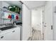 Efficient laundry area and a view into a half bathroom, designed for convenience and functionality at 3679 S Zeno Way, Aurora, CO 80013