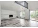 Bright living room with a charming brick fireplace, and sliding glass doors, offering access to the outdoor deck at 3679 S Zeno Way, Aurora, CO 80013