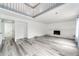 Bright and airy living room featuring neutral paint, laminate floors, fireplace, and a loft area at 3679 S Zeno Way, Aurora, CO 80013