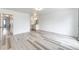 Large main bedroom with light wood-look floors, bright walls, and a view of the ensuite bathroom at 3679 S Zeno Way, Aurora, CO 80013