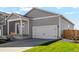 Attractive home featuring a two-car garage, covered porch, and neutral gray siding at 7326 Green River Ave, Frederick, CO 80530