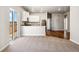 Open-concept living area with hardwood flooring and access to sliding glass doors at 7326 Green River Ave, Frederick, CO 80530