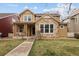 Charming two-story home with stone accents, a welcoming front porch, and a well-manicured lawn at 14214 Waterside Ln, Broomfield, CO 80023