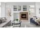 Warm living room with a cozy fireplace, built-in shelving, and stylish seating for relaxed living at 14214 Waterside Ln, Broomfield, CO 80023