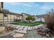 Backyard oasis featuring artificial grass, patio area with seating and stone pathway at 8645 Coors St, Arvada, CO 80005