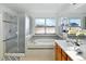 Bright primary bathroom with a soaking tub, glass shower, and vanity with modern countertop at 8645 Coors St, Arvada, CO 80005