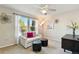 Bright bedroom featuring a comfortable sofa, ottomans, and large windows with scenic views and natural light at 8645 Coors St, Arvada, CO 80005