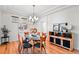 Bright dining room with modern chandelier, glass table and unique decorative accents at 8645 Coors St, Arvada, CO 80005