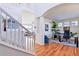 Welcoming foyer featuring a staircase and an office with natural light and hardwood flooring at 8645 Coors St, Arvada, CO 80005