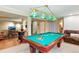 Basement game room with pool table, bar area, and comfortable seating for entertaining at 8645 Coors St, Arvada, CO 80005