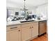 Modern kitchen featuring white cabinets, stainless steel appliances, a central island, and a stylish black faucet at 8645 Coors St, Arvada, CO 80005