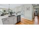 Open-concept kitchen with white cabinetry, quartz countertops, and stainless steel appliances at 8645 Coors St, Arvada, CO 80005