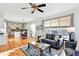 Inviting living room with hardwood floors, a comfortable sofa, and plenty of natural light from large windows at 8645 Coors St, Arvada, CO 80005