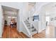 Elegant staircase with white banisters and a view into the dining room, highlighting the home's open design at 8645 Coors St, Arvada, CO 80005