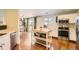 White kitchen with stainless steel appliances, island with butcher block countertop, and adjacent dining area at 9380 Jackson St, Thornton, CO 80229