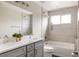 Beautiful bathroom featuring a double vanity, a soaking tub, and elegant neutral tiling at 2134 S Galapago, Denver, CO 80223