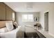This is a lovely primary bedroom with large windows, a paneled wall, modern decor, and lots of natural light at 2134 S Galapago, Denver, CO 80223