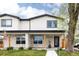 Charming home features a stone facade, black framed windows, and a welcoming front porch at 2134 S Galapago, Denver, CO 80223