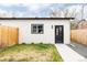 Charming detached garage with modern black door and lush green yard with a walkway at 2134 S Galapago, Denver, CO 80223