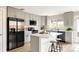 Stylish kitchen with stainless steel appliances, island with barstools, and grey cabinets at 2134 S Galapago, Denver, CO 80223