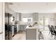 Eat-in kitchen features sleek stainless steel appliances and access to an outdoor patio area at 2134 S Galapago, Denver, CO 80223