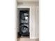 This laundry room features a brand new, black, stacked washer and dryer set at 2134 S Galapago, Denver, CO 80223