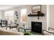 Stylish living room boasts a modern fireplace, comfortable seating, and abundant natural light at 2134 S Galapago, Denver, CO 80223