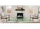 Bright living room features a cozy fireplace, comfortable seating, and picture windows at 2134 S Galapago, Denver, CO 80223