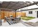 A beautiful patio with seating under a pergola and black and white outdoor rug at 2134 S Galapago, Denver, CO 80223