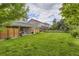 Green backyard featuring covered patio area and lush lawn at 26072 E Fremont Pl, Aurora, CO 80016