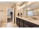 Bathroom showcasing double sinks and vanity, modern mirror and lighting and a view to the main bedroom at 26072 E Fremont Pl, Aurora, CO 80016