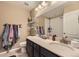 Bright bathroom featuring marble countertops, neutral walls, and convenient towel racks at 26072 E Fremont Pl, Aurora, CO 80016
